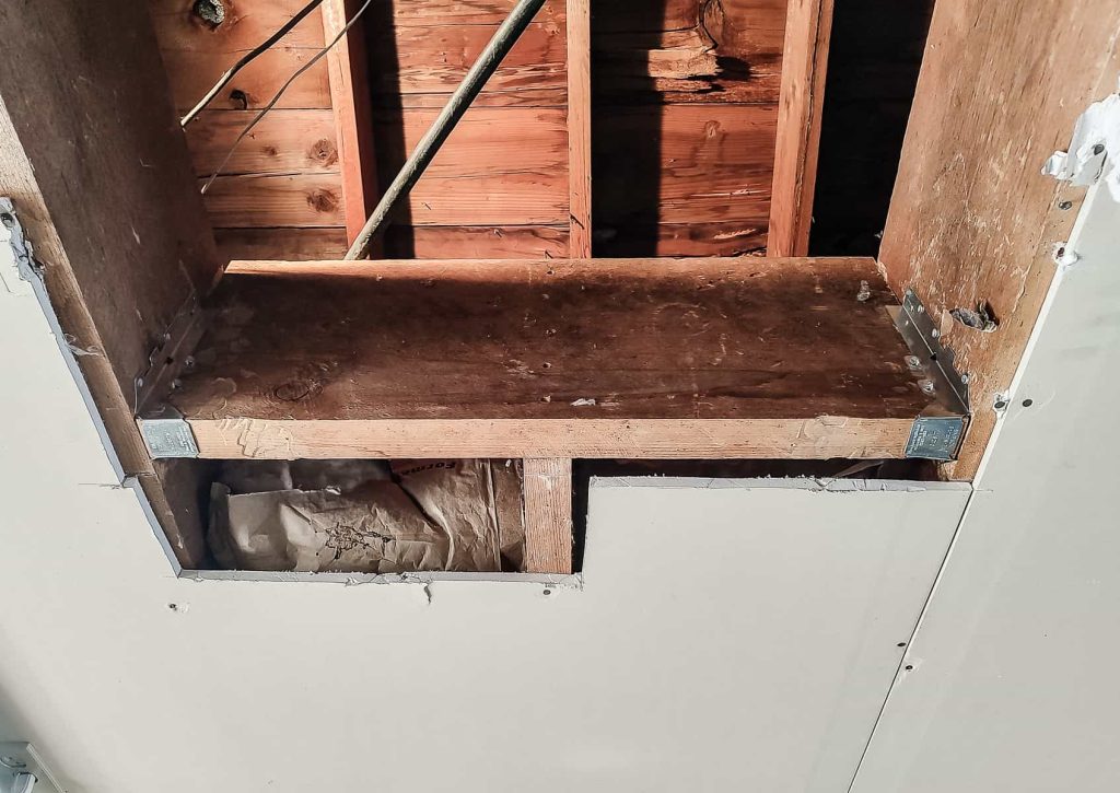 Adding some extra strength and stability with joist hangers to prepare a rough opening for an attic ladder