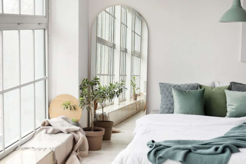 A mirror helps small bedrooms feel larger by bouncing the light around the room 