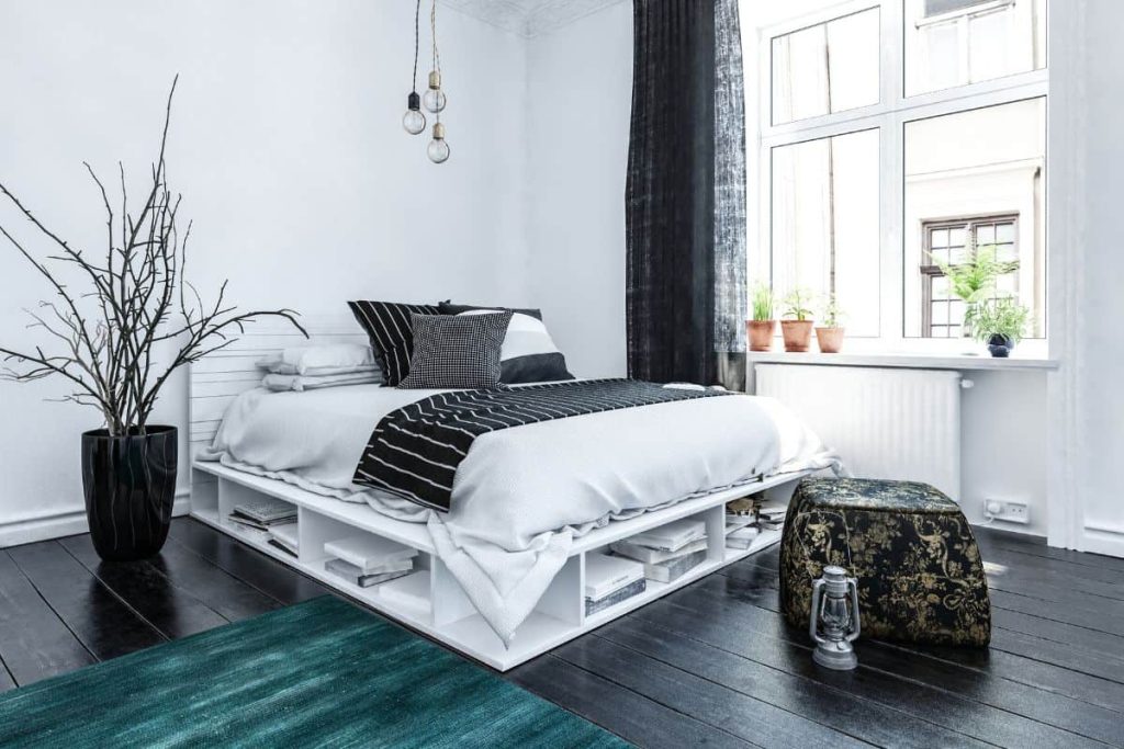 Adding a storage bed, like this one with shelves on. the bottom edges, is a great idea if you have a smaller bedroom