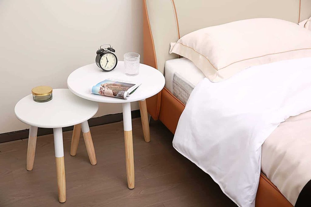 Modern nesting tables that can be tucked away are an alternative to a nightstand in a bedroom that doesn't have a lot of space