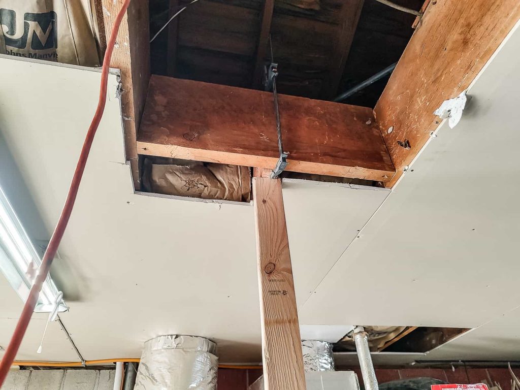 Using clamps and other means to flush up the header with the joists to create a seamless transition