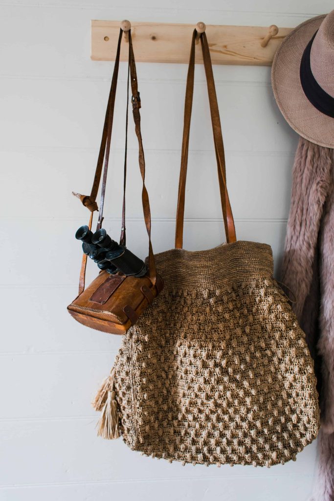 Wall hooks or a peg rail like this allows you to store hang bags, hats, jackets and more in your tiny bedroom