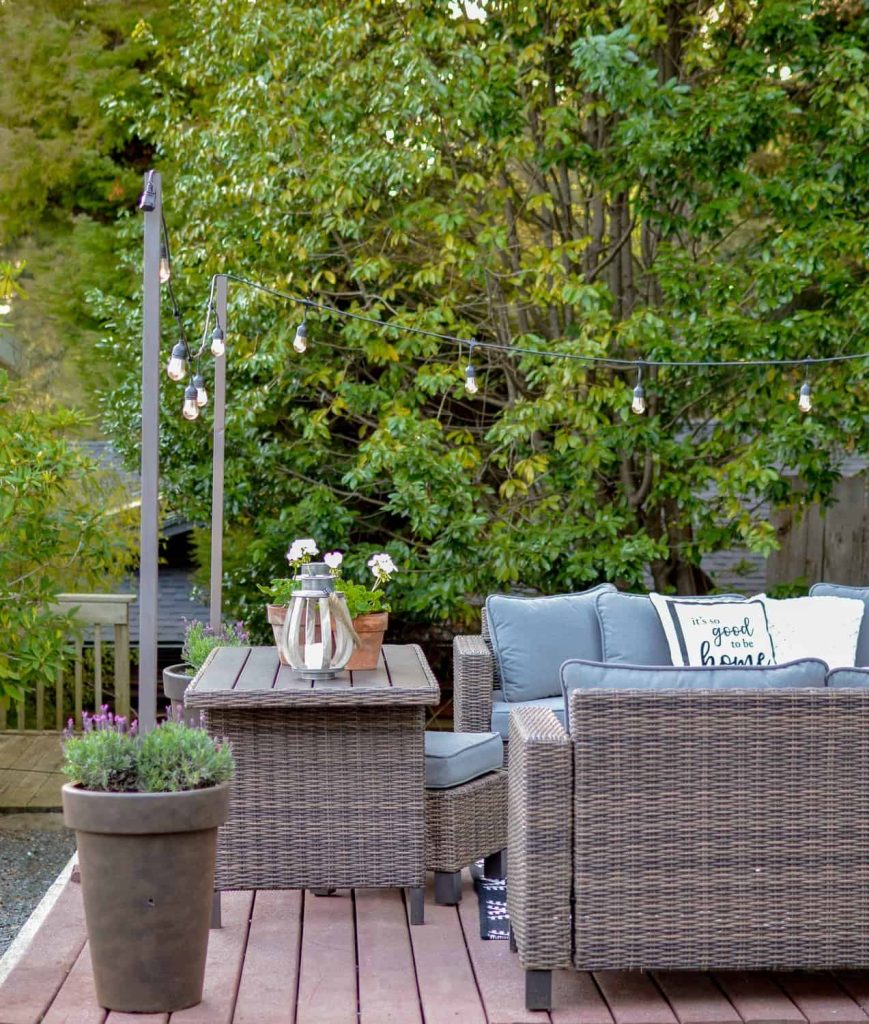 Make string light pole holders with diy planter pots like this for your backyard deck