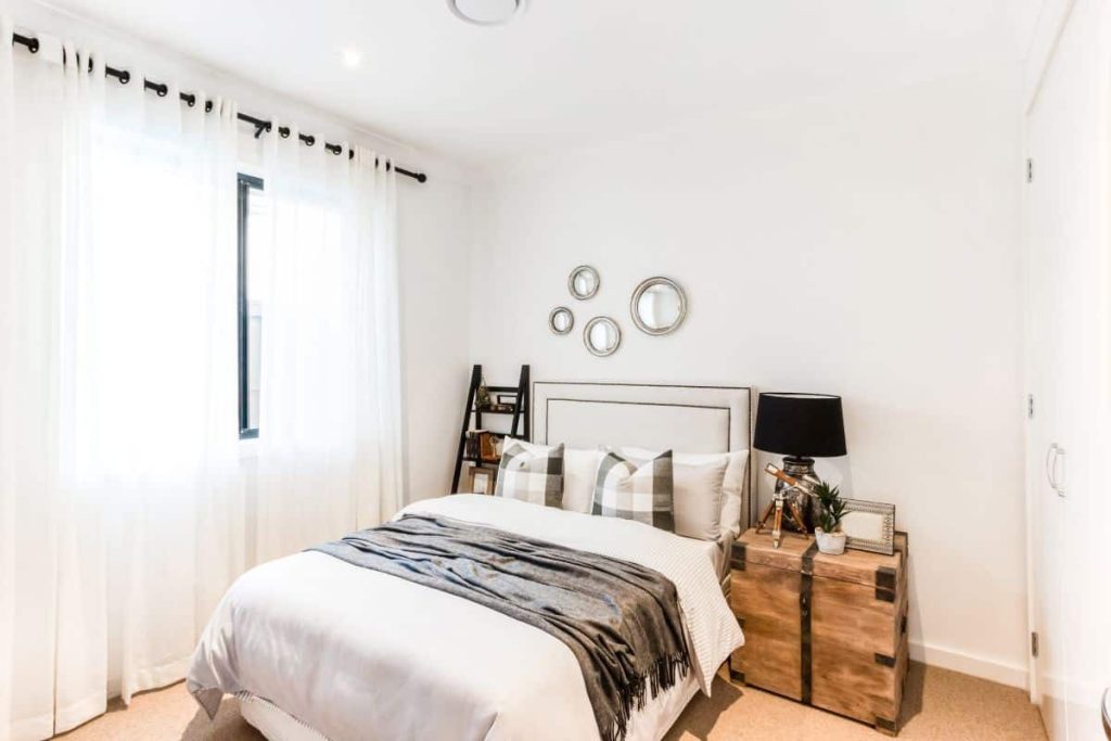 Lighter colors for bedding and paint is a great way to make your bedroom look and feel bigger than it is 