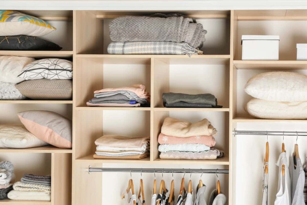 Utilize the top shelves of. your closet for folded blankets, pillows, and sweaters or other things you don't reach for often