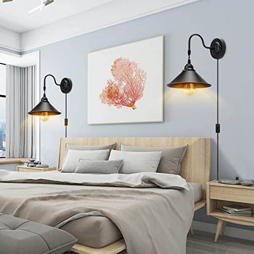 Wall mounted lights, like these wall scones, are great for small bedrooms and free up space on your nightstand