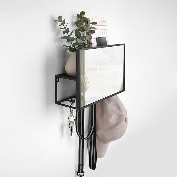 This mirror serves double duty with hooks on the bottom for holding keys and hats and a shelf behind 