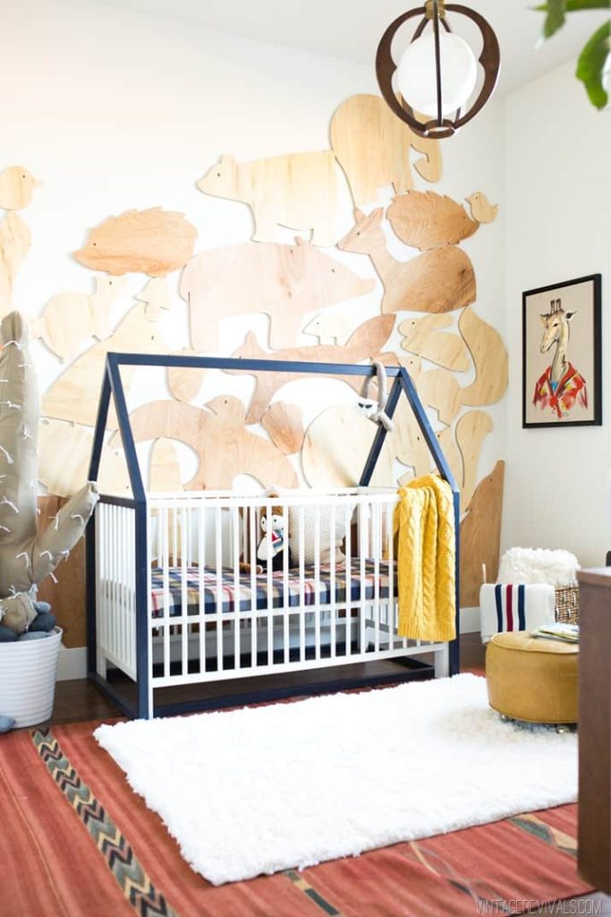 Using a red rust color as the main focal color in a nursery with other accents on the walls 