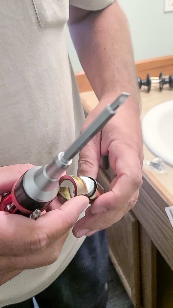 Slipping on the ring for the latch to put into a door panel that is made for the ring 