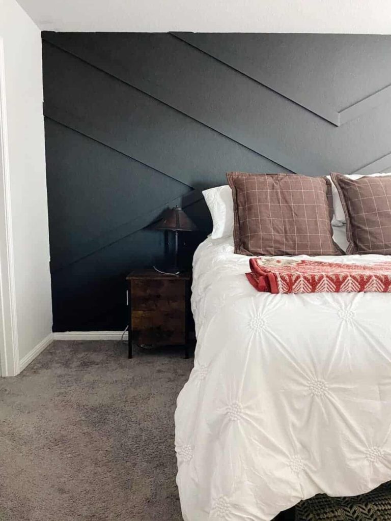 If you're looking for a good black paint color for an accent wall in your bedroom, consider Limousine Leather by Behr Paint