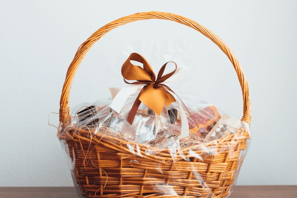 Put the items of your themed gift basket into a wicker basket and wrap it with cellophane and tie with a bow for a nice presentation to your housewarming basket. 