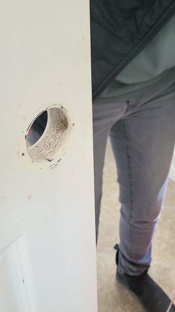 an empty door panel with the door knob removed to replace with an interior door handle