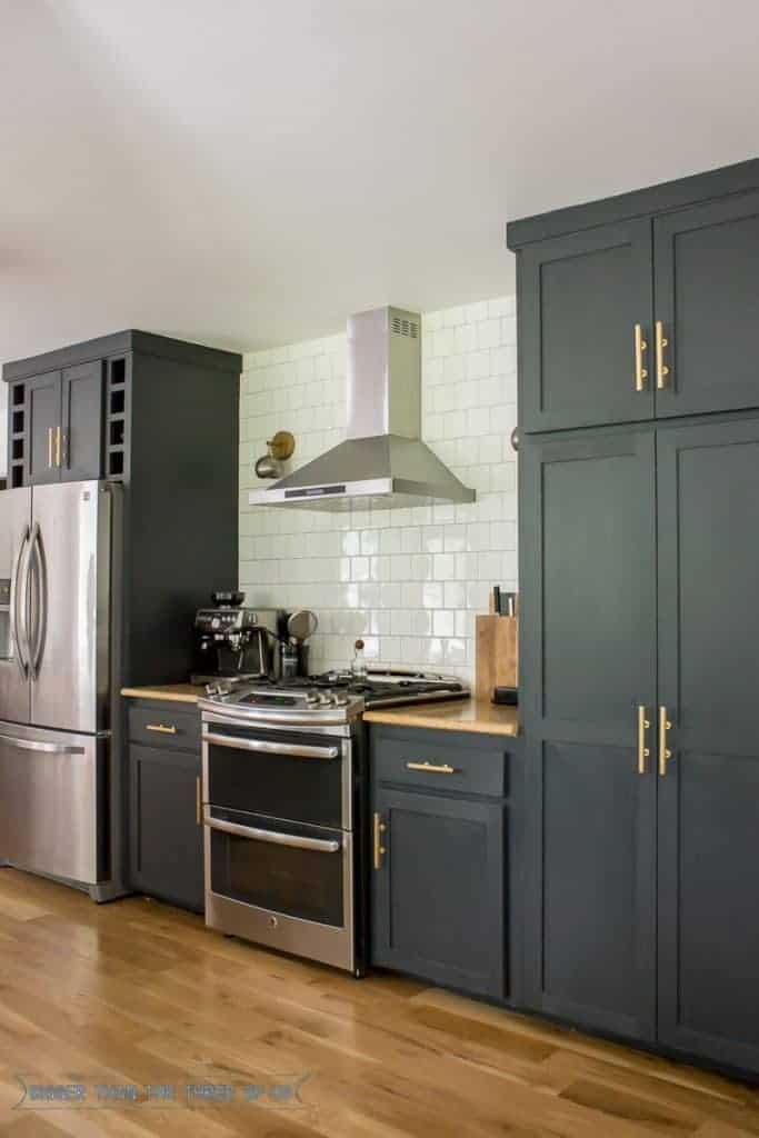 This pretty kitchen features black painted cabinetry with Behr Cracked Pepper