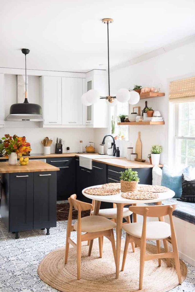 I this modern two-toned kitchen with dark lower cabinets and white upper cabinets with wood toned butcher block countertops