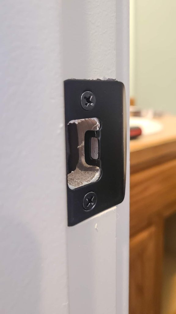 Replacing a striker place with two screws and a phillips head screwdriver to use for a new door handle replacement