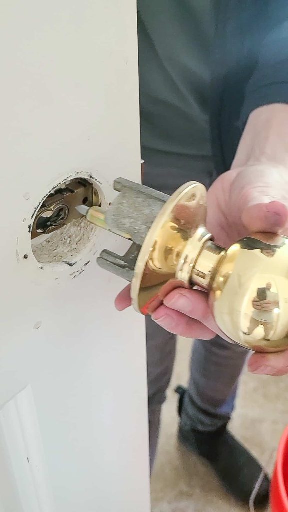 Removed door knob as part of a replace interior door handles tutorial from brass color 