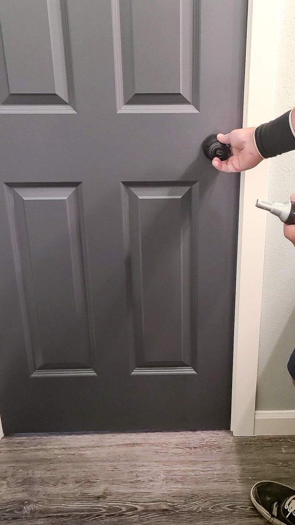 Checking the fit on the door to see if it closes properly and the latch and striker plate fit together