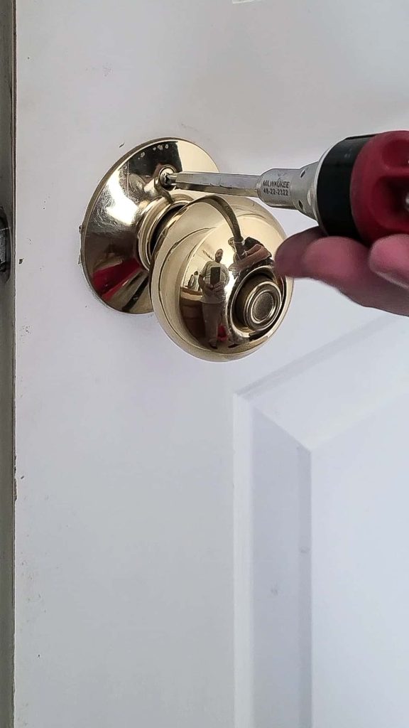 Using a phillips head screwdriver to replace door handles start by removing screws 