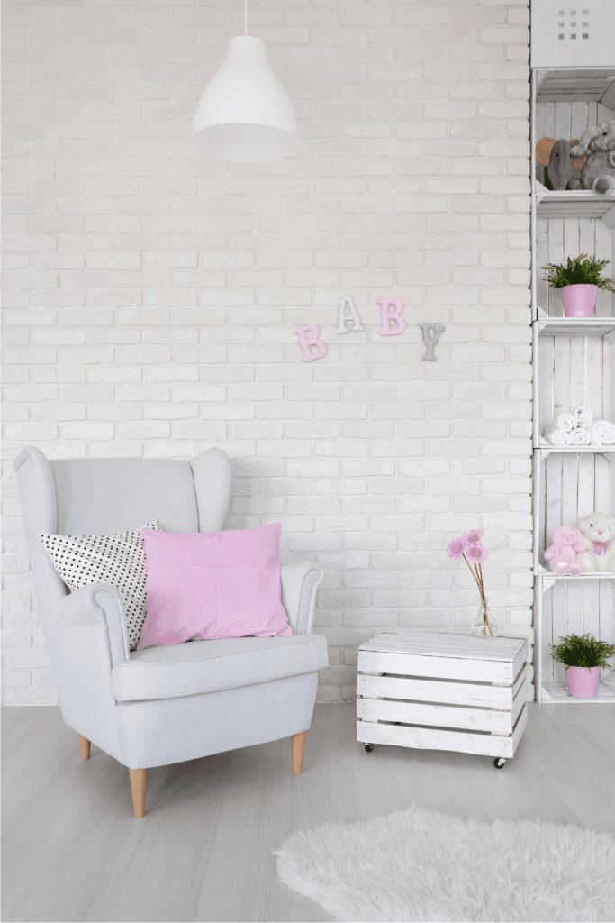 Using grey as a nursery color idea but using pink accent pieces to add variety to the room
