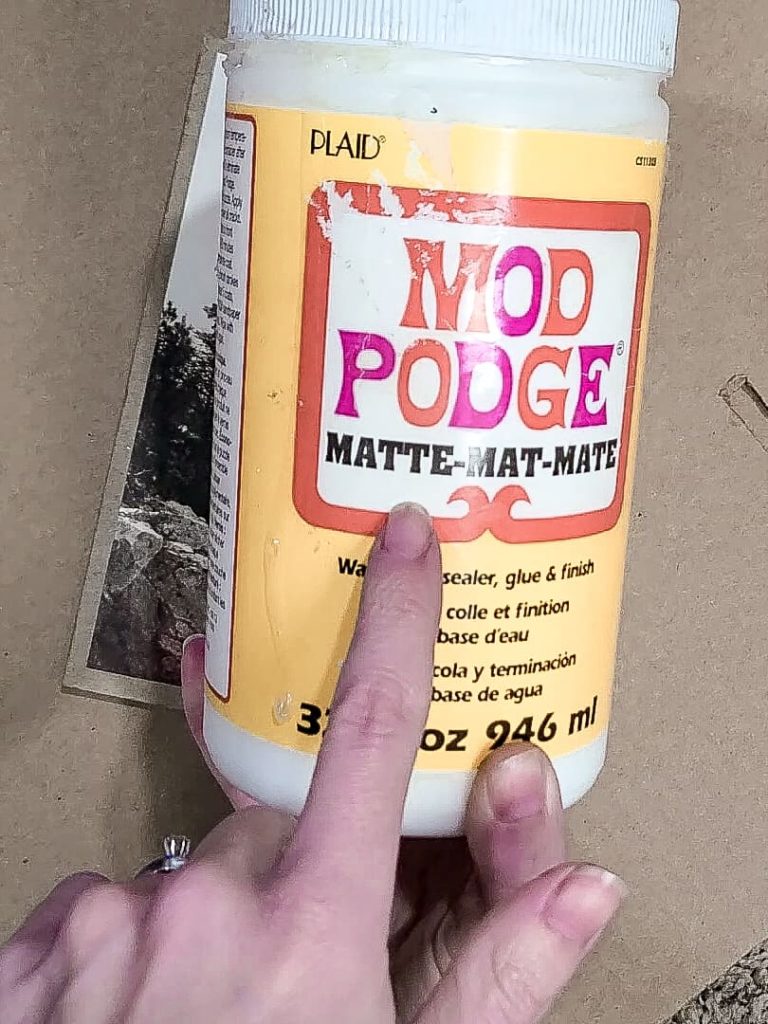 Use mod podge to put a layer over the print and cardboard in a matte finish to make it look like a painting