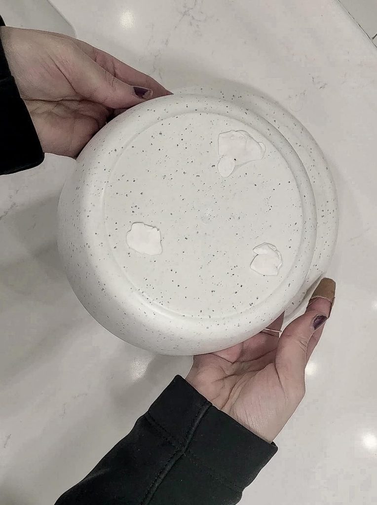 Put Museum Putty on the bottom of the smaller bowl before pressing it into place on the bottom of the larger bowl to make the DIY footed bowl
