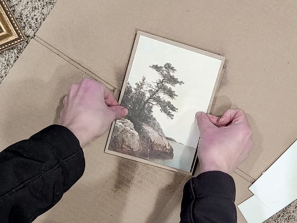 Gluing the print to the carboard backer in order to get it ready to make it look like a painting
