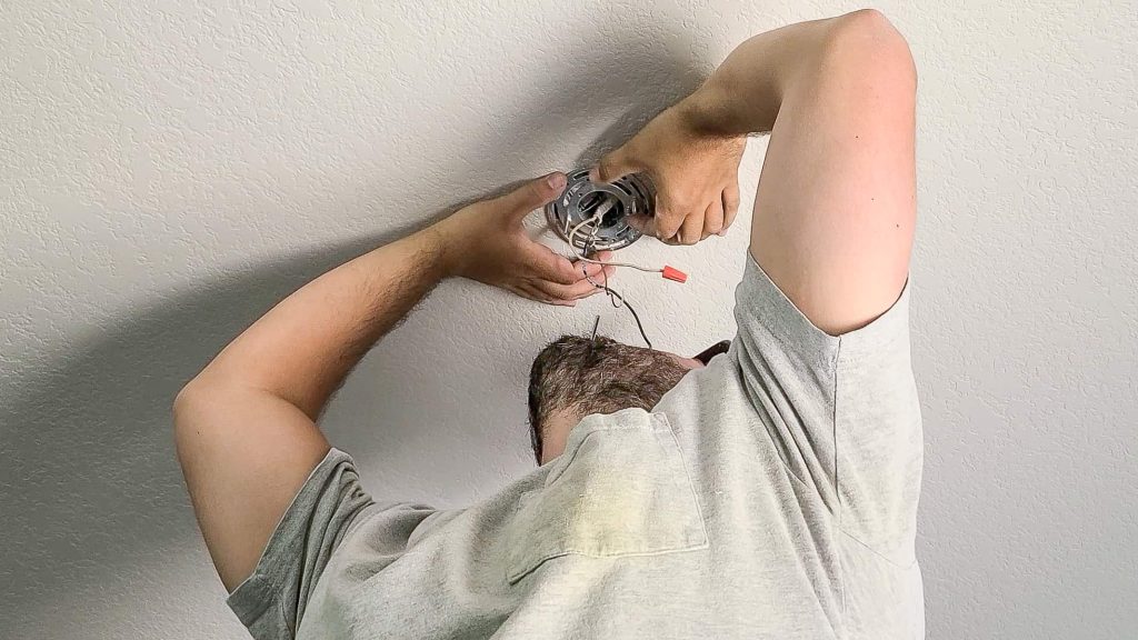 Installing a new ceiling light bracket in order to replace it with a new light in a dining room