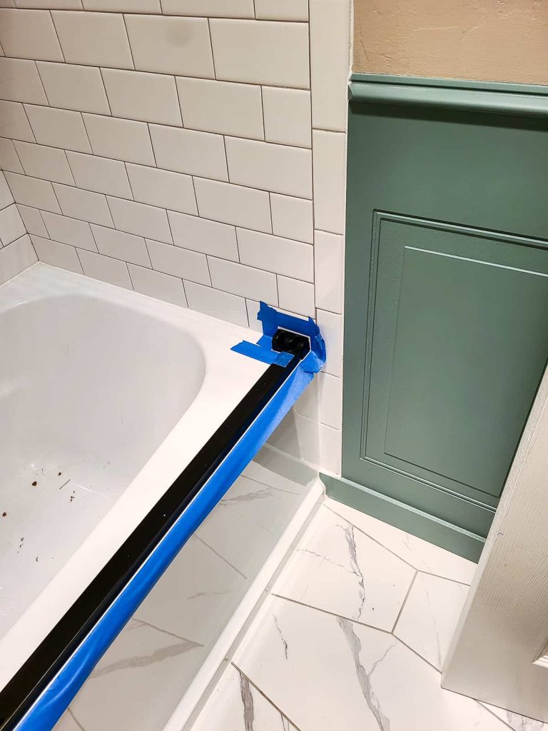 Taping the surrounding surface to ensure a streamlined and neat caulk line even after tooling 