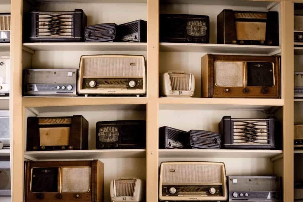 displaying vintage radios in a modern boho design on the interior of a home on shelves