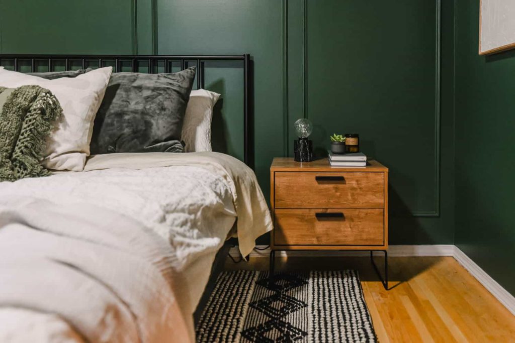 behr vine leaf paint color used in bedroom on all four walls with picture frame trim 