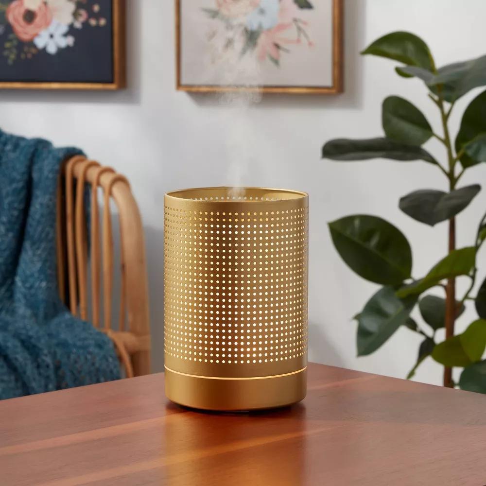 Modern boho style often incorporates metallic accents like brass and gold to add a touch of glamour to the space. These accents can be used in light fixtures, hardware, decor items, and furniture, like this brass metal diffuser. 