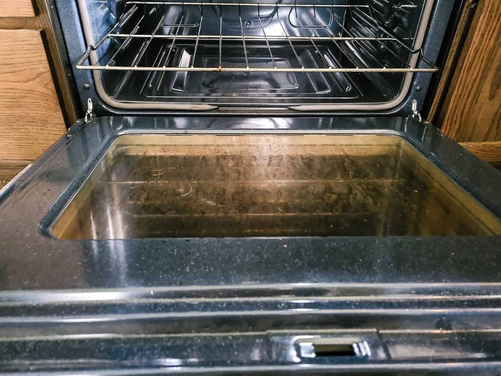 showing the inside of the gas stove that is a bout to be cleaned to show how dirty a range gets from normal use