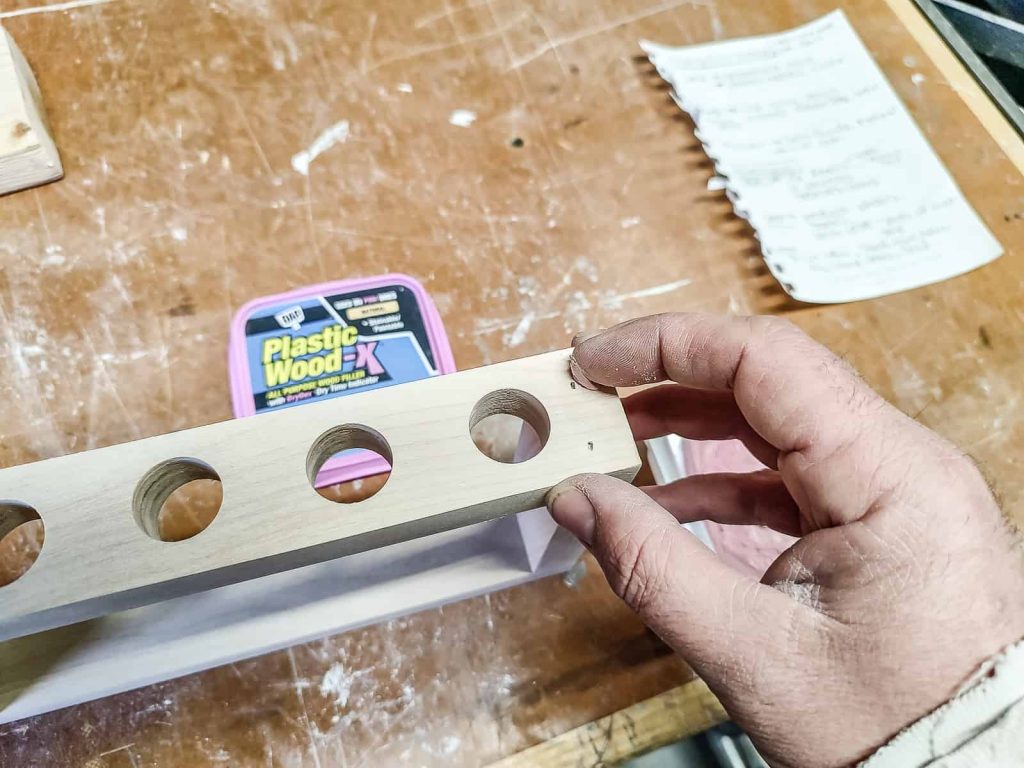 filling nail holes with wood filler that is stainable and paintable to hide the nails used to join the wood together