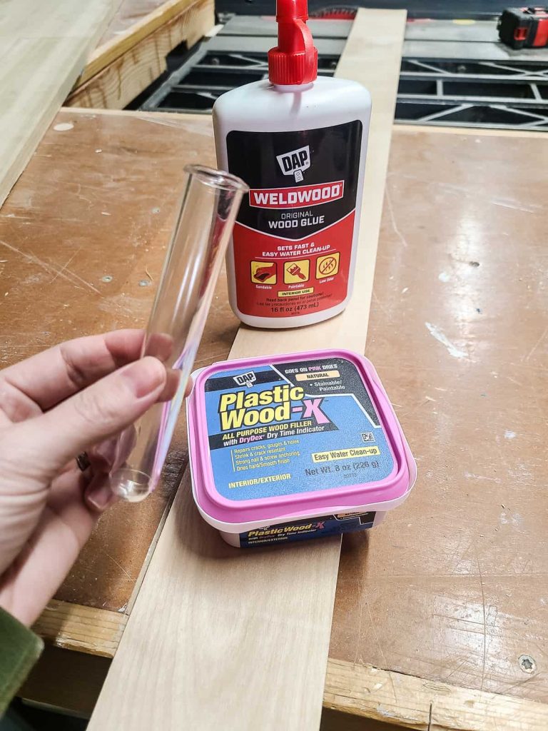 Materials for a diy propagation station including wood glue, plastic wood x filler and a long piece of wood 