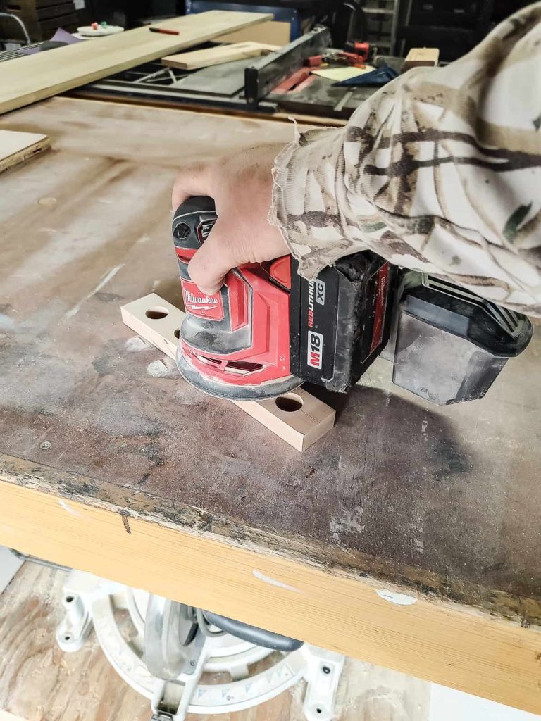Sanding down pieces for a project with a battery random orbital sander to get a clean scratch free surface