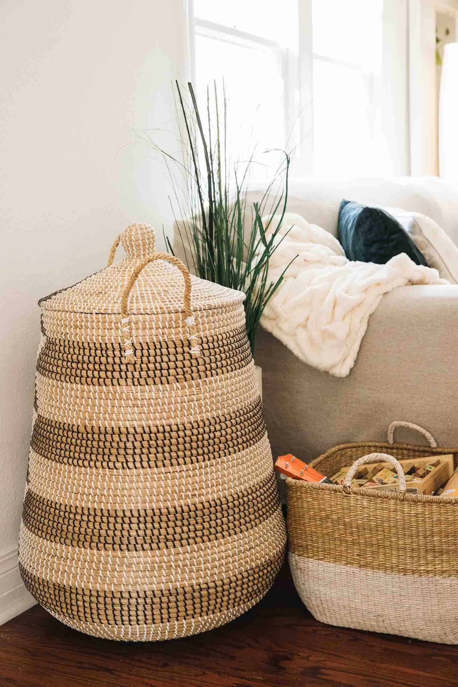 wicker baskets next to sofa used as toy storage