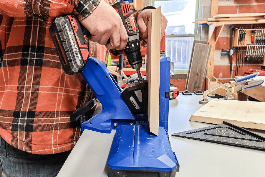 Skilled man using a 720PRO drill to create a hole in the wood
