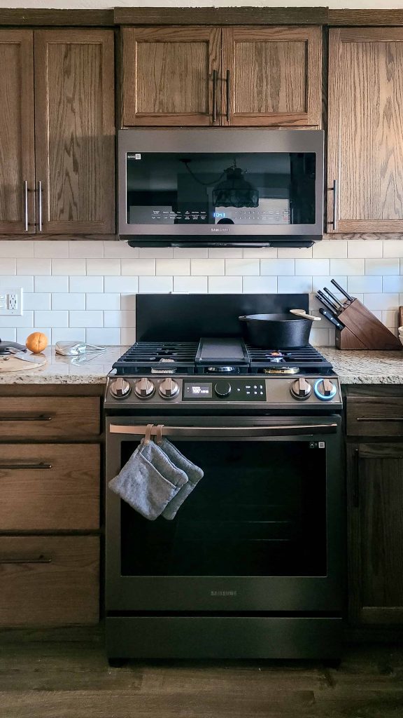 a photo of a  Samsung Bespoke Gas Range and some kitchen tools.