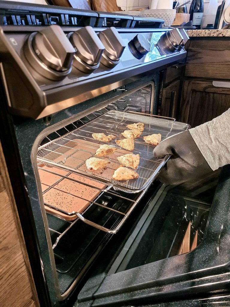 A person baking with a Samsung Bespoke Gas Range