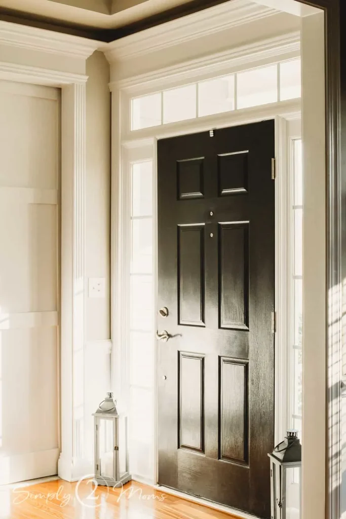 Looking for a black door paint color ideas? Check this out! This paint color on the inside of the front door in this entry is Onyx by Benjamin Moore, which is a dark and true black paint color