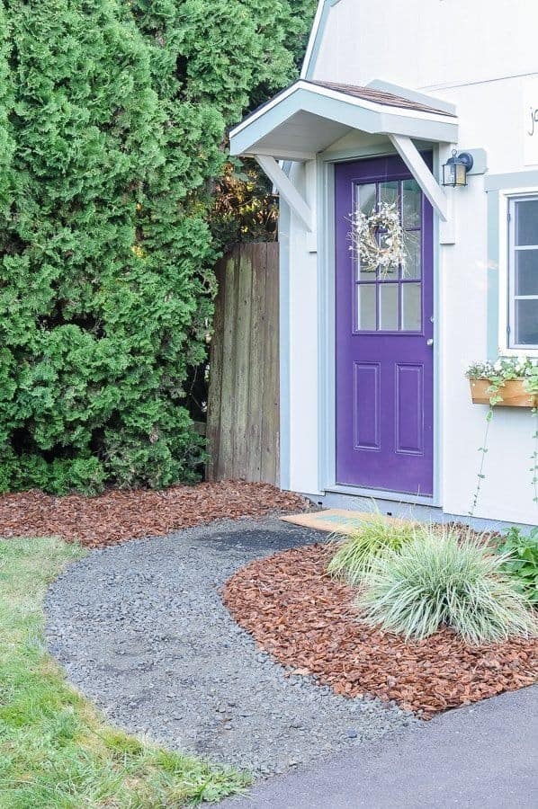 small portico over purple front door.