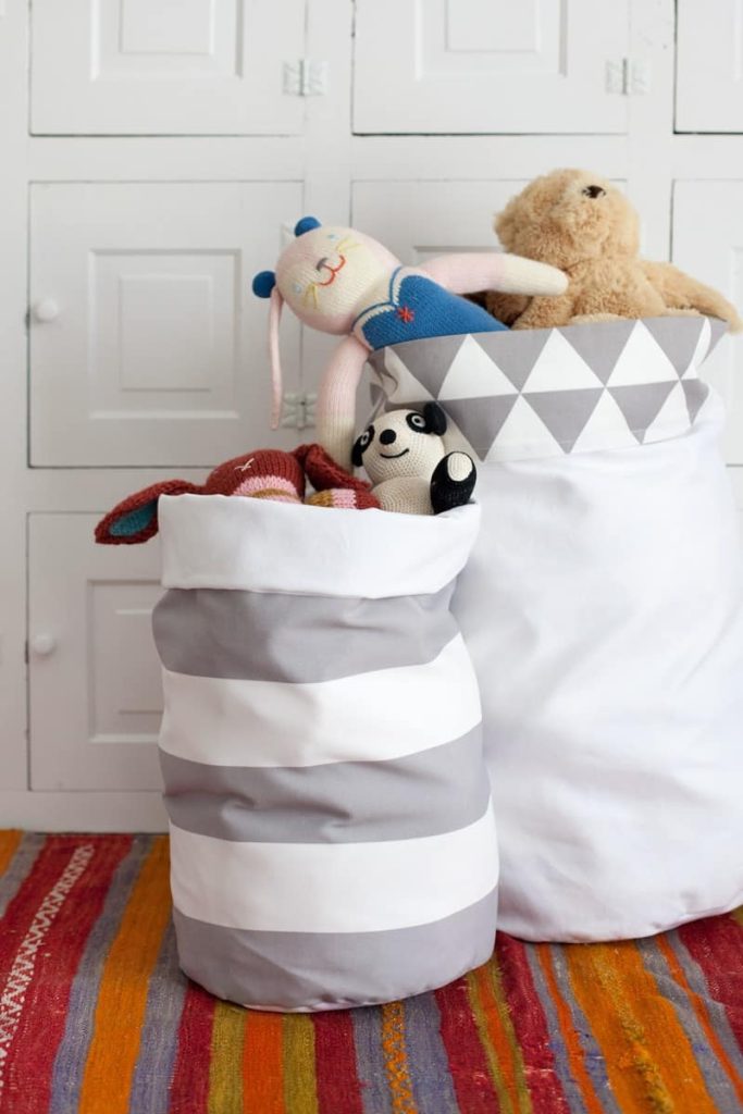 DIY tall fabric storage bins with stuffed animals in them