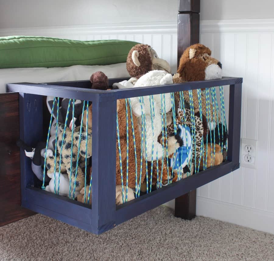DIY wooden and paracord stuffed animal storage attached to the end of the bed