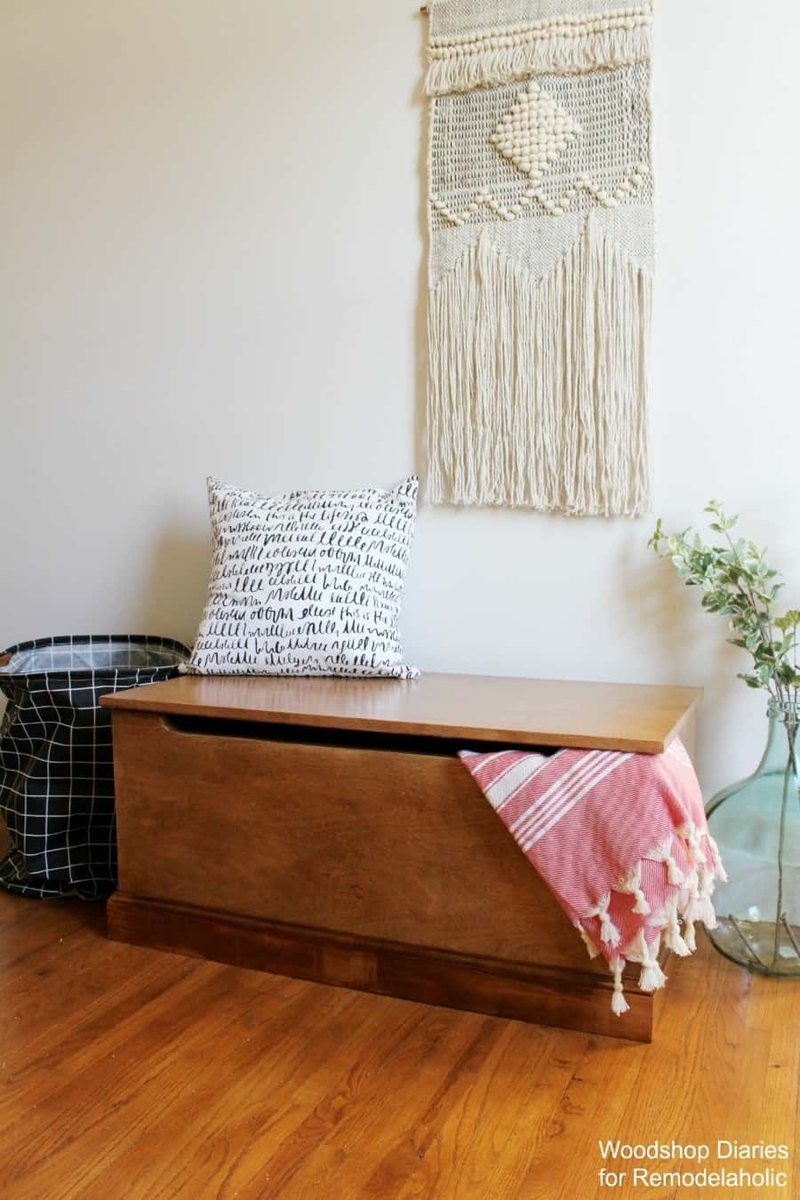 DIY toy box with blanket hanging out from underneath the lid