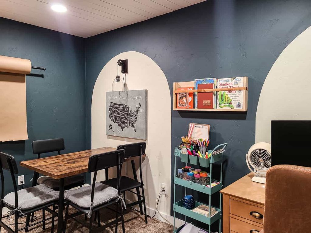 A well-organized room featuring a DIY wooden shelf with neatly arranged items.