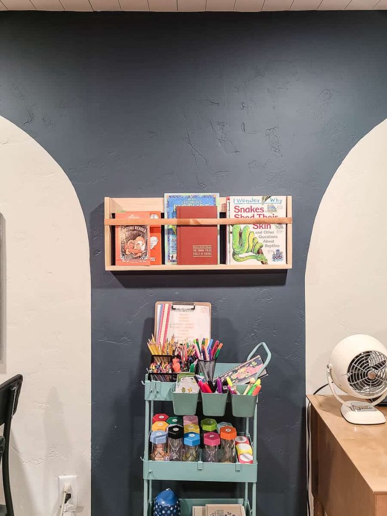 DIY wooden bookshelf filled with a collection of books with rack organizer for other reading materials.
