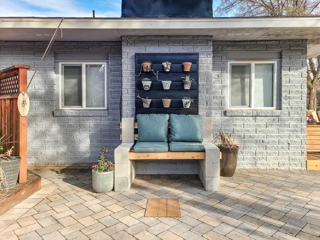 Learn how an outdoor space can be finished with concrete blocks, wooden planks for seating and potted plants.