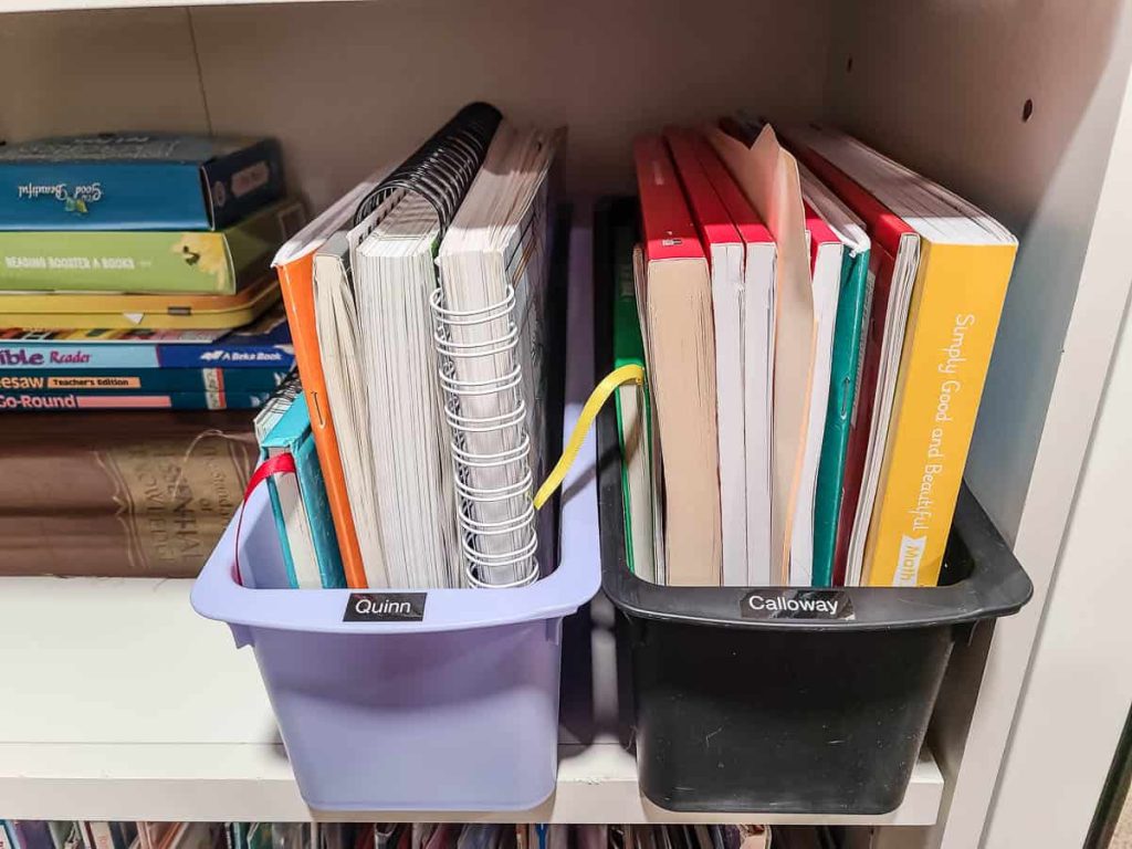 An image on the middle section of the shelf showing the book bin with homeschooling curriculum for each kid