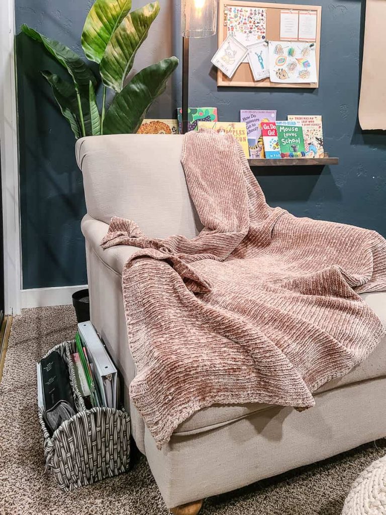 Couch in a cozy room featuring a collection of textbooks.