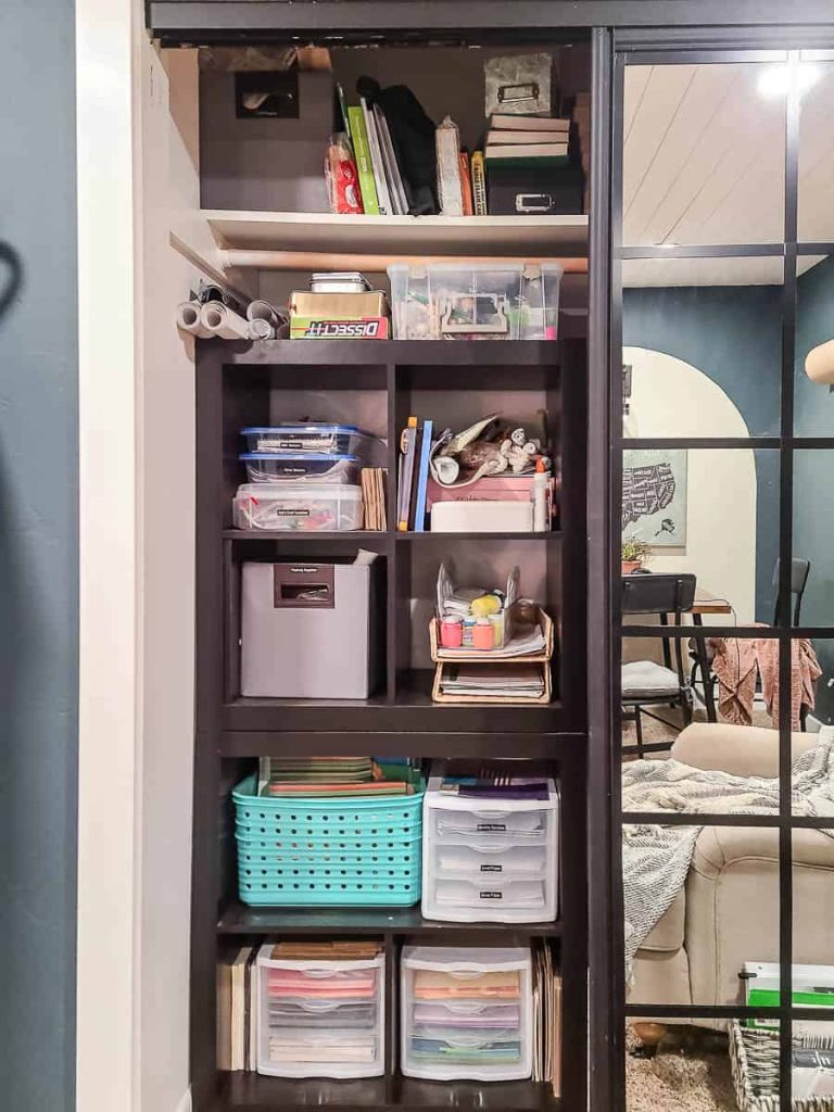 Closet with sliding mirror doors revealing organized storage racks, offering a space-efficient and stylish solution for keeping essentials tidy and accessible.